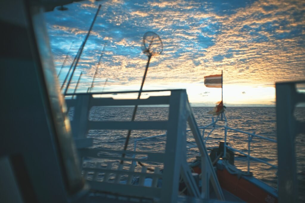 a boat with a flag on the water